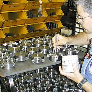 Back inside the building and next to the grinding room, the chuck department assembles and tests each 3-jaw and 4-jaw chuck. In this photo, lubrication is being applied to a batch of 4-jaw chucks. Over 25 years of making our own chucks has allowed us to continually improve their accuracy while keeping costs down.